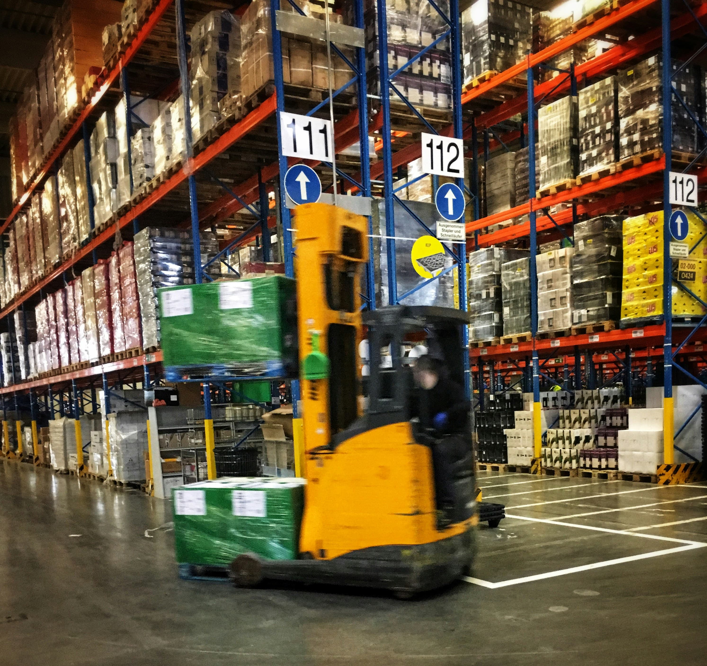 Forklift moving through an industrial warehouse